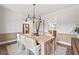 Charming dining area featuring a chandelier and a wooden table with seating for six at 707 Mirror Lake Parkway Way, Villa Rica, GA 30180
