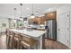 A modern kitchen with a large island, stainless steel appliances, and stylish pendant lighting at 707 Mirror Lake Parkway Way, Villa Rica, GA 30180