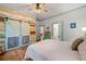 Cozy bedroom featuring a queen-sized bed, wood-paneled accent wall, and barn door closet at 7550 Fielder Rd, Jonesboro, GA 30236