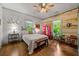 Comfortable bedroom with hardwood floors, light wood accent walls and lots of natural light at 7550 Fielder Rd, Jonesboro, GA 30236