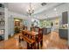 Open dining area flows into a modern kitchen with stainless steel appliances and an island at 7550 Fielder Rd, Jonesboro, GA 30236