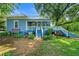 Charming blue home with white trim, a metal roof, and inviting front porch with blue steps and landscaping at 7550 Fielder Rd, Jonesboro, GA 30236