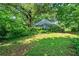 Charming blue home nestled among mature trees offers a serene and private setting at 7550 Fielder Rd, Jonesboro, GA 30236