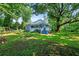 Quaint blue home with inviting front porch nestled among mature trees at 7550 Fielder Rd, Jonesboro, GA 30236