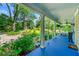Covered front porch with blue floor, ample space, and views of the landscaped front yard at 7550 Fielder Rd, Jonesboro, GA 30236