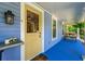 Inviting front porch with a yellow door, bench seating, and classic outdoor lighting at 7550 Fielder Rd, Jonesboro, GA 30236