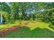 Charming home with a lush front yard, mature trees, and inviting curb appeal, perfect for outdoor enjoyment at 7550 Fielder Rd, Jonesboro, GA 30236