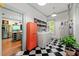 Spacious laundry room with black and white checkered floors and stainless steel appliances at 7550 Fielder Rd, Jonesboro, GA 30236