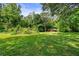Lush backyard with mature trees and an outbuilding at 7550 Fielder Rd, Jonesboro, GA 30236