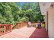 An inviting wooden deck with outdoor seating amidst lush greenery and partial shade at 10312 Waterford Ne Rd, Covington, GA 30014