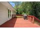 This wood deck features a grill under a cover, and ample space to relax and entertain at 10312 Waterford Ne Rd, Covington, GA 30014