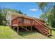 Exterior of home showing a wood deck and stairs in backyard at 10312 Waterford Ne Rd, Covington, GA 30014