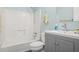 A full bathroom with a shower-tub combo and a gray vanity with sink and chrome faucet at 10312 Waterford Ne Rd, Covington, GA 30014