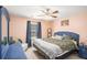 Comfortable bedroom with ceiling fan, window, dresser and coordinated furnishings at 10312 Waterford Ne Rd, Covington, GA 30014