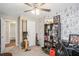 This bedroom has distinctive wallpaper, a ceiling fan, and a rowing machine at 10312 Waterford Ne Rd, Covington, GA 30014