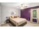 Cozy bedroom with ceiling fan, picture window, side table and modern decor at 10312 Waterford Ne Rd, Covington, GA 30014