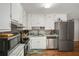 Updated kitchen features stainless steel appliances, white cabinets, and granite countertops at 10312 Waterford Ne Rd, Covington, GA 30014