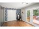 View of kitchen with stainless appliances, closet, and patio access to the outdoor living space at 10312 Waterford Ne Rd, Covington, GA 30014