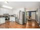 Open kitchen with stainless appliances flows into living area with statement wall and exterior access at 10312 Waterford Ne Rd, Covington, GA 30014