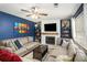 Cozy living room featuring a fireplace, hardwood floors, and ample seating at 10312 Waterford Ne Rd, Covington, GA 30014