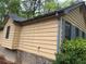 Home exterior with siding and brick foundation, complemented by green foliage at 2513 Rockwood Way, Stone Mountain, GA 30087