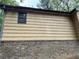 Close up of yellow siding and brick, highlighting architectural details of the home at 2513 Rockwood Way, Stone Mountain, GA 30087