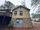 Exterior showing the garage underneath the deck with brick underpinning at 2513 Rockwood Way, Stone Mountain, GA 30087