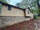 Exterior view showcasing the home's foundation and the surrounding landscape at 2513 Rockwood Way, Stone Mountain, GA 30087
