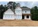 Exterior view of home under construction with house wrap and wooded backdrop at 3435 Dr Bramblett Rd, Cumming, GA 30028