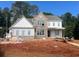 New home under construction shows brick exterior with double-hung windows and contrasting white trim at 3435 Dr Bramblett Rd, Cumming, GA 30028