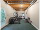 Basement with exercise equipment, open ceiling and french door exit at 3580 Treeline Ne Pass, Roswell, GA 30075