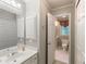 Well-lit bathroom with white cabinets, large mirror and convenient access to the water closet at 3580 Treeline Ne Pass, Roswell, GA 30075