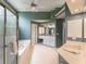 Well-lit primary bath features a glass shower, tub and dual sink vanity at 3580 Treeline Ne Pass, Roswell, GA 30075