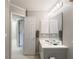 Neutral-toned bathroom with a double vanity, a large mirror and convenient closet access at 3580 Treeline Ne Pass, Roswell, GA 30075