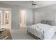 Bright bedroom with white walls, a metal bedframe, and view into the bathroom at 3580 Treeline Ne Pass, Roswell, GA 30075
