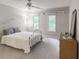 Sun-filled bedroom featuring neutral tones and a large window overlooking a peaceful landscape at 3580 Treeline Ne Pass, Roswell, GA 30075