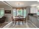 Cozy dining area featuring hardwood floors, large windows, and view into the kitchen at 3580 Treeline Ne Pass, Roswell, GA 30075