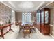Formal dining room with decorative wallpaper, and a dark wood china cabinet at 3580 Treeline Ne Pass, Roswell, GA 30075