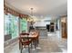 Dining room featuring hardwood floors, large windows, and adjacent to a modern kitchen at 3580 Treeline Ne Pass, Roswell, GA 30075