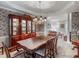 Elegant dining area with a large table, china cabinet, and a view into the living room at 3580 Treeline Ne Pass, Roswell, GA 30075