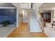 Bright and airy entryway featuring hardwood floors, a staircase, and elegant trim details at 3580 Treeline Ne Pass, Roswell, GA 30075