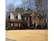 Charming brick home featuring a well-manicured lawn and traditional architectural design at 3580 Treeline Ne Pass, Roswell, GA 30075