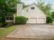 Home with a two car garage, extended driveway and mature landscaping at 3580 Treeline Ne Pass, Roswell, GA 30075
