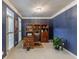 Comfortable home office with hardwood floors, blue walls, built in bookshelf, and natural light at 3580 Treeline Ne Pass, Roswell, GA 30075