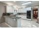 Well-lit kitchen with white cabinets, granite countertops and stainless steel appliances at 3580 Treeline Ne Pass, Roswell, GA 30075