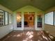 Covered porch showcasing its access to the home's interior, providing a view of the living space at 3580 Treeline Ne Pass, Roswell, GA 30075