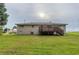 A view of the spacious backyard featuring a well-maintained lawn and the house exterior at 2290 Pope Rd, Douglasville, GA 30135