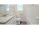 Bathroom featuring granite countertop, white cabinets, framed mirror and tub with shower at 2290 Pope Rd, Douglasville, GA 30135