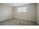 Bedroom with neutral walls, carpet, and a window bringing in natural light at 2290 Pope Rd, Douglasville, GA 30135