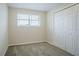 Neutral bedroom featuring carpeted floors, double closet and window with blinds at 2290 Pope Rd, Douglasville, GA 30135